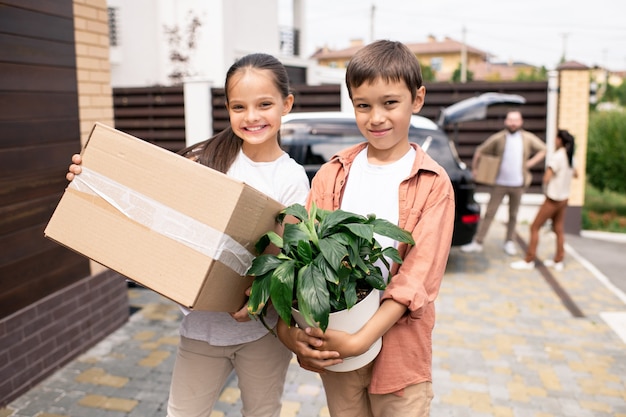 Positive kids with plant and box