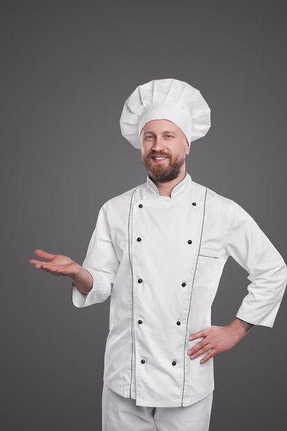 Positive male chef in uniform and hat