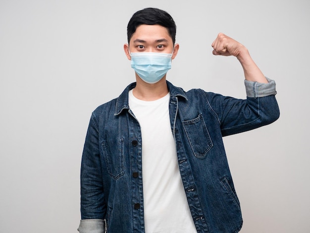 Positive man jeans shirt wear medical mask good healthy show muscle