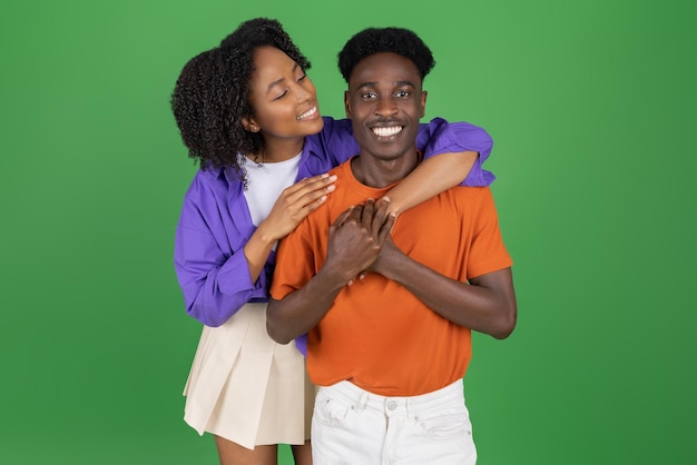 Positive millennial african american woman hug guy in casual enjoy date