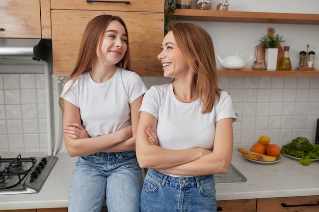 Positive mother and daughter in kitchen