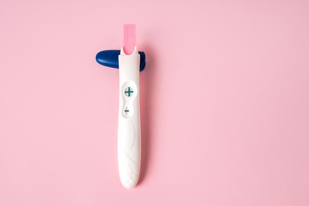 A positive pregnancy test on a background Minimalism and a place for text