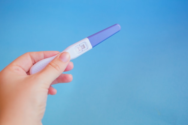 Positive pregnancy test with two strips on pink