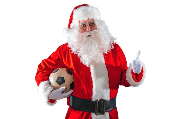 Positive santa claus with football ball in hand