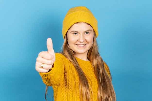 Positive teenager girl thumbs up