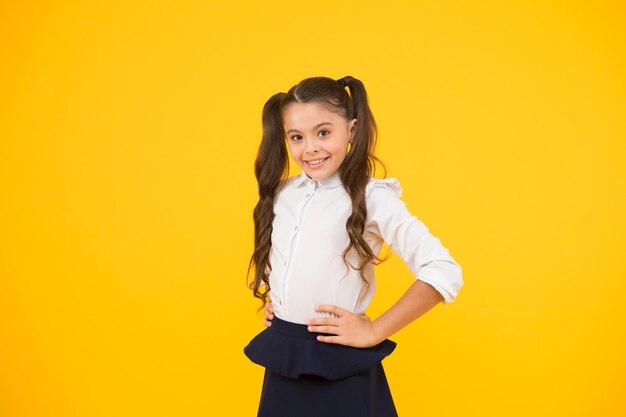 Positive vibes School life concept Celebrate knowledge day Emotional school girl Successful graduation Happy childrens day Student little kid Girl pupil on yellow background Back to school