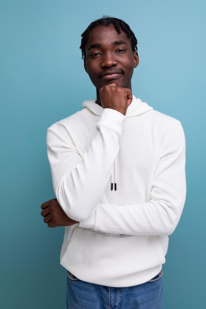 Positive young african guy in white sweatshirt