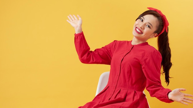 Positive young beautiful female with straight hair in ponytail dressed in casual clothing looking at camera and pleasantly smiling rejoicing life