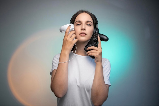 positive young female in casual clothes holding VR controller and console gamepad