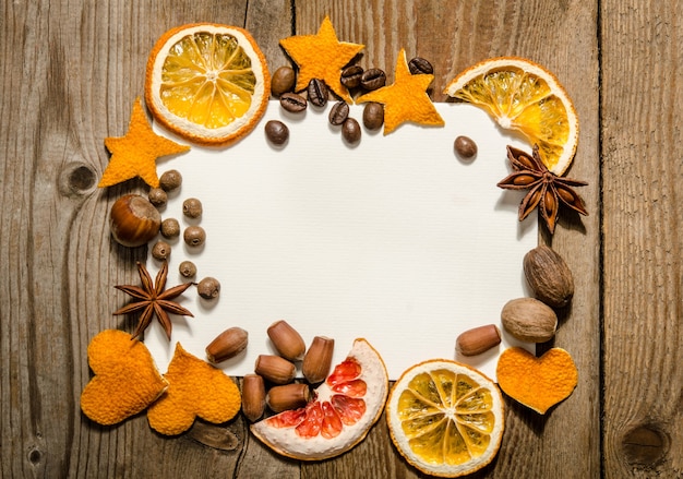 Postcard in a frame made of citrus, nuts and spices