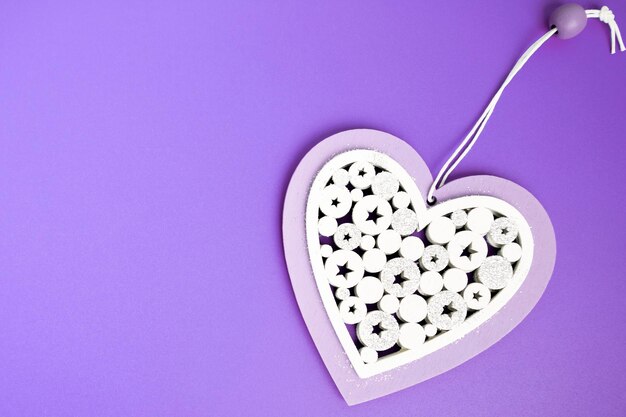 Postcard to the Valentines day white Heart on a purple background with copy space