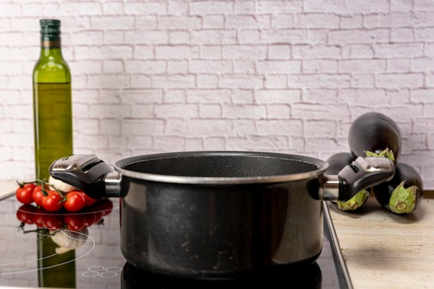 A pot of boiling water on an electric stove in the kitchen