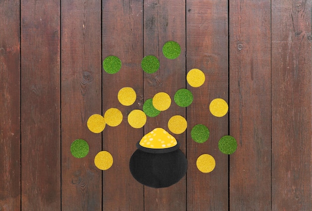 Photo pot of gold and coins for st patricks day on wood