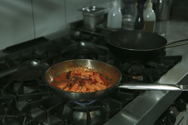 pot with pasta on the fire stove cooking