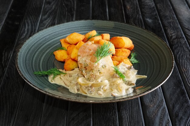 Potato balls with chicken fillet and mushroom and onion sauce