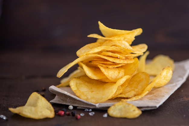 Potato chips in bowl on a wooden background, Selective focus