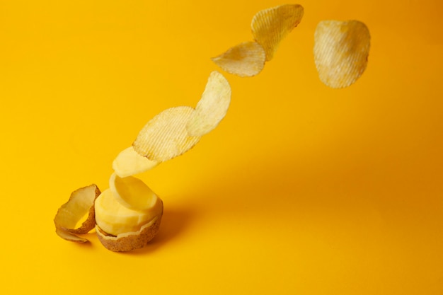 Potato chips fly on a yellow background