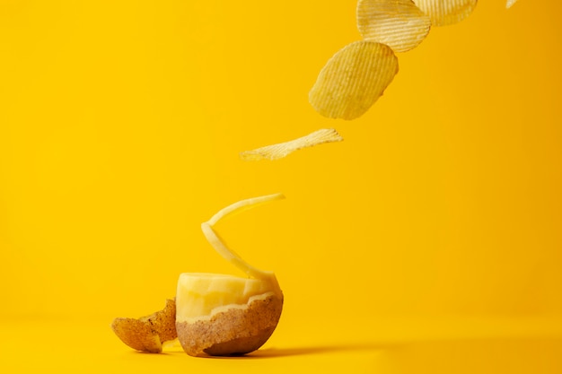 Potato chips fly on a yellow background