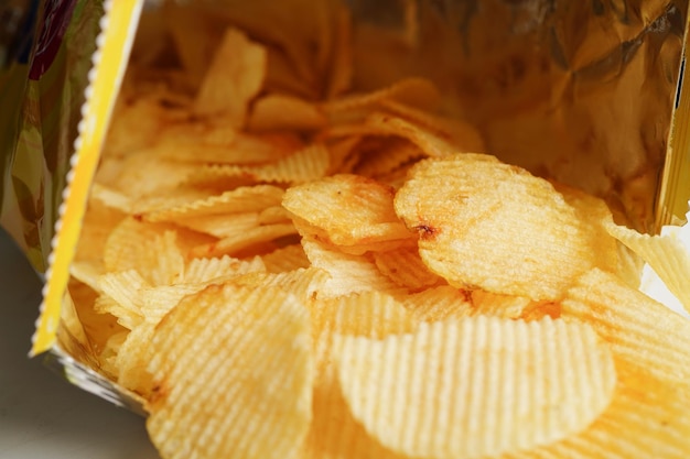 Potato chips in open bag delicious BBQ seasoning spicy for crips thin slice deep fried snack fast food