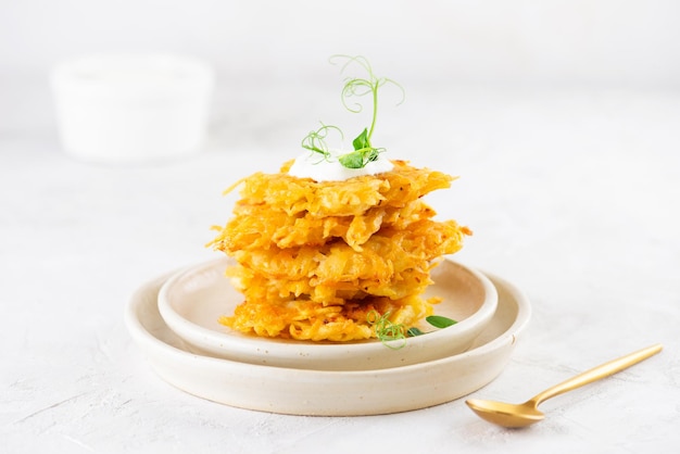 Potato pancakes draniki Latkes or Levivot with sour cream green in a stack Hanukkah Passover food