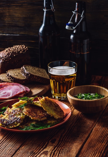 Potato Pancakes with Sour Cream, Greens, Smoked Meat and Glass of Beer