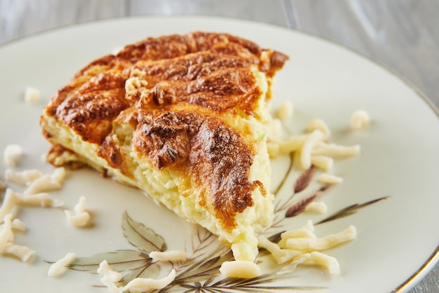 Potato zucchini cauliflower and yellow cheese souffle on plate