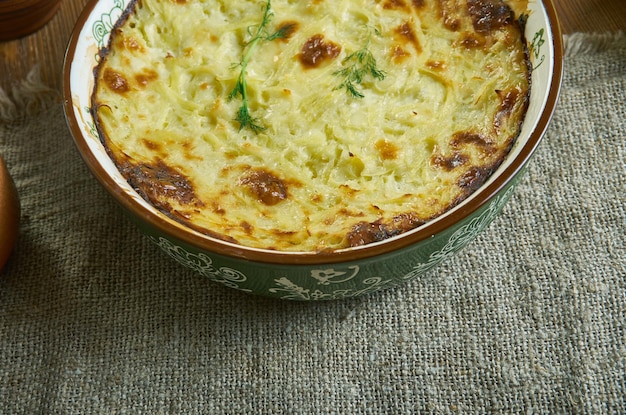 Potatoes Romanoff, baked with sour cream, green onions and processed cheese , Russian 19th century classic cuisine , assorted  dishes, Top view.