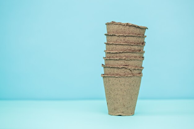 Pots for seedlings on a blue background