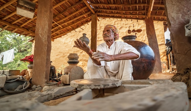 Potter at work makes ceramic dishes India Rajasthan