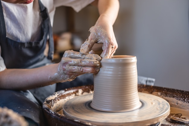 Potter working on a Potter's wheel making a vase