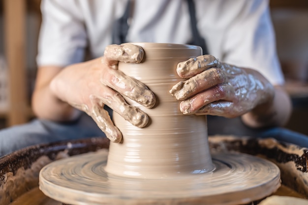 Potter working on a Potter's wheel making a vase