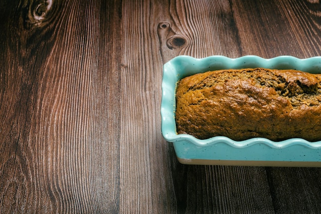 Pound cake in blue mold on wooden table Homemade banana pound cake