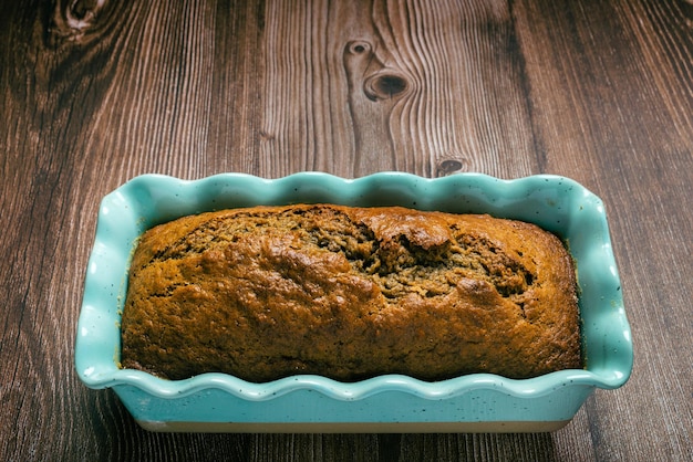 Pound cake in blue mold on wooden table Homemade banana pound cake