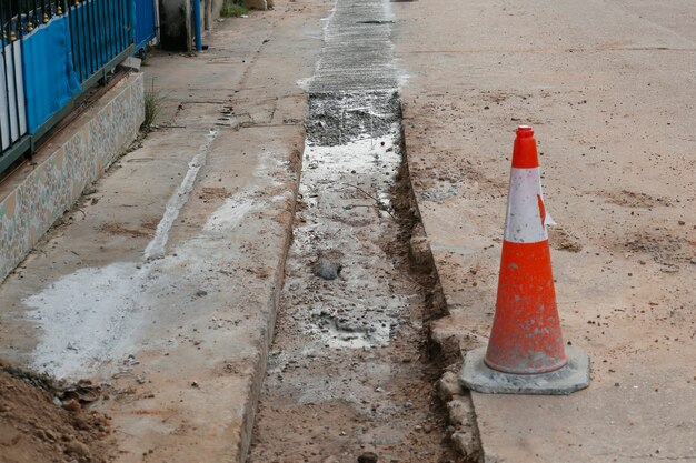 Pour concrete on the pipe line in a rural village road.