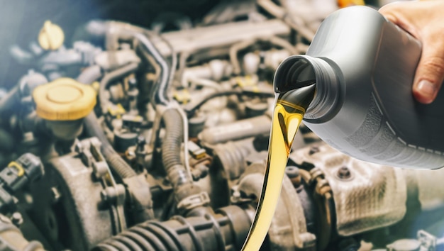 Pour motor oil into car engine. Maintenance service change liquids and fluid.