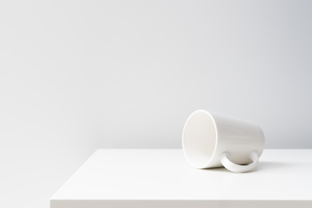 A poured white ceramic mug on the table