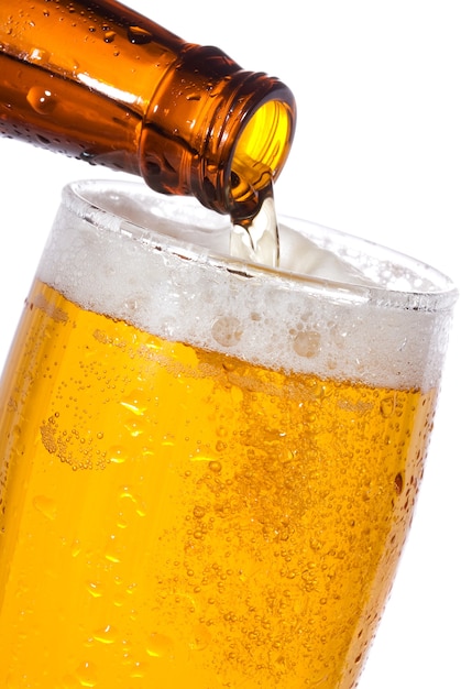 Pouring beer in a glass isolated on white 