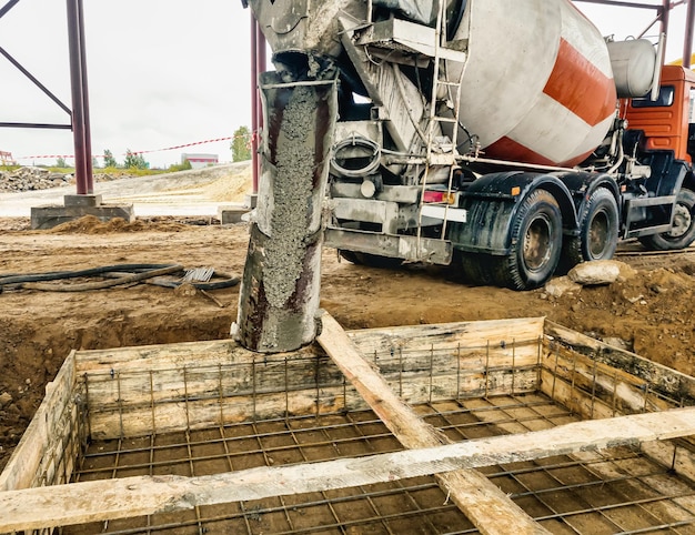 Pouring the foundation with concrete at the construction site Monolithic reinforced concrete works during the construction of the building