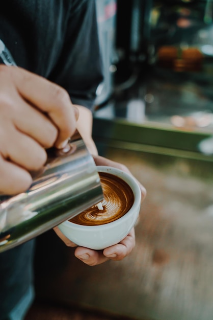 Pouring milk for making latte art coffee