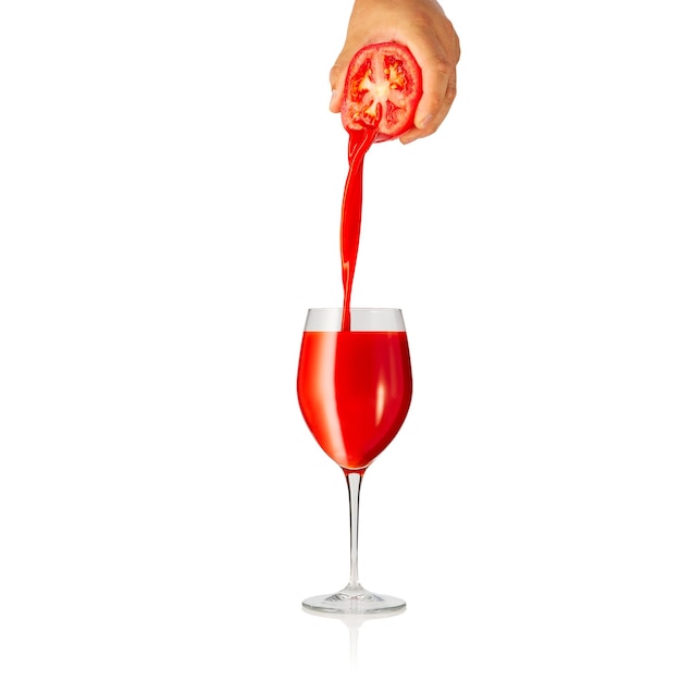 Pouring tomato juice to glass isolated on white background pouring tomato juice from fresh tomato