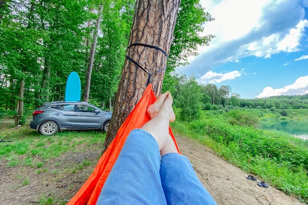 pov man laying down on hammock car with supboard on background