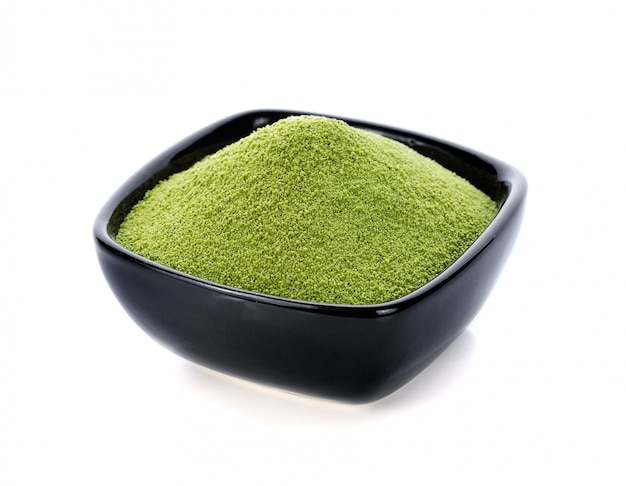 Powder green tea isolated on white