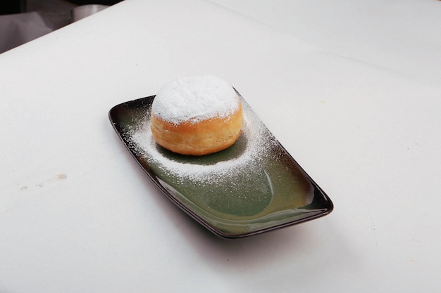 Powder sugar fall over donuts Berliner