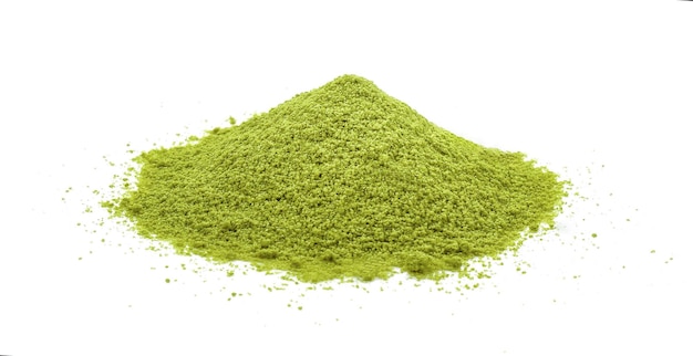 Powdered matcha green tea scattered on white background