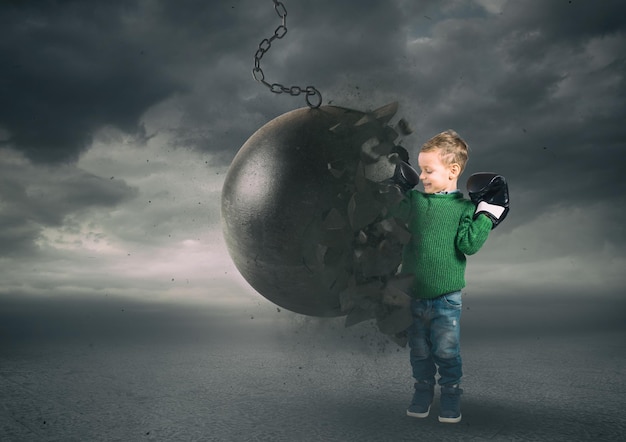 Power and determination of a child against a wrecking ball