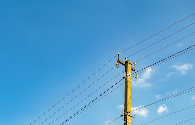 Power electric pole with line wire on colored background close up