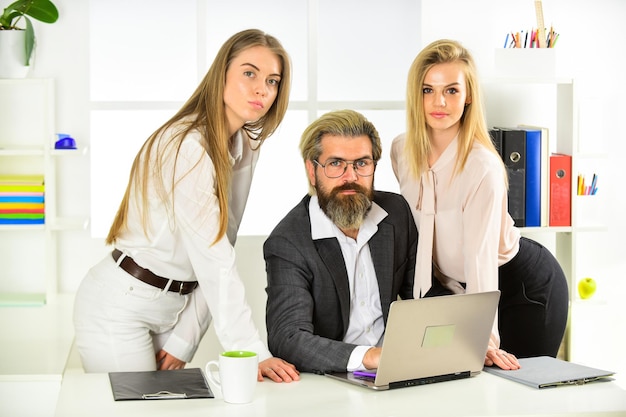 Power is in his hands colleagues brainstorming in talk chatting explain ideas at workplace business colleagues in modern office boss is surrounded by assistants women and man discuss work issues