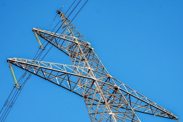 Power line on blue sky closeup Mast energy electricity