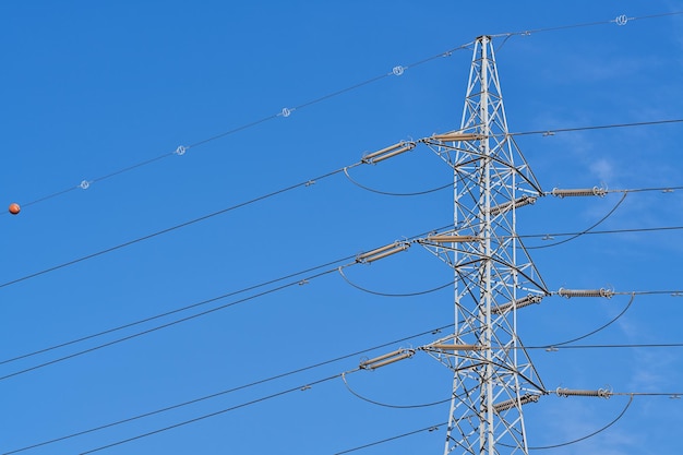 Power line tower with blue sky background