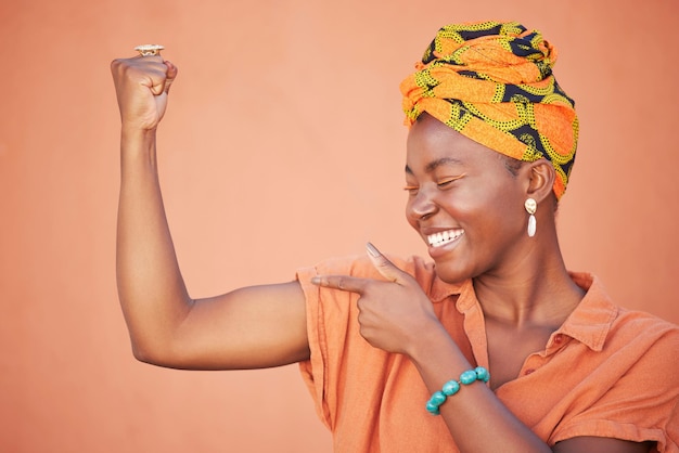 Power strong and arm flex with black woman for leadership gender equality and confident Muscle proud and fitness with bicep and fist of girl for success tough and strength in orange background